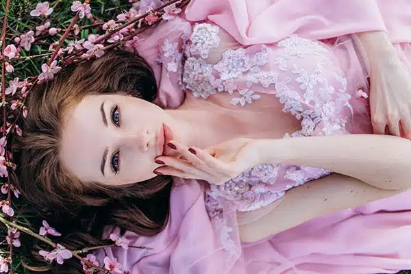 Young Girl In A Pink Flowered Garden