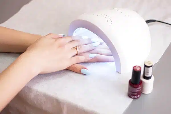 Woman Using UV Light Dryer