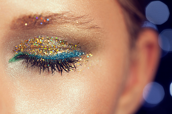 glitter on the eyelashes of the girl. the festive evening make-u
