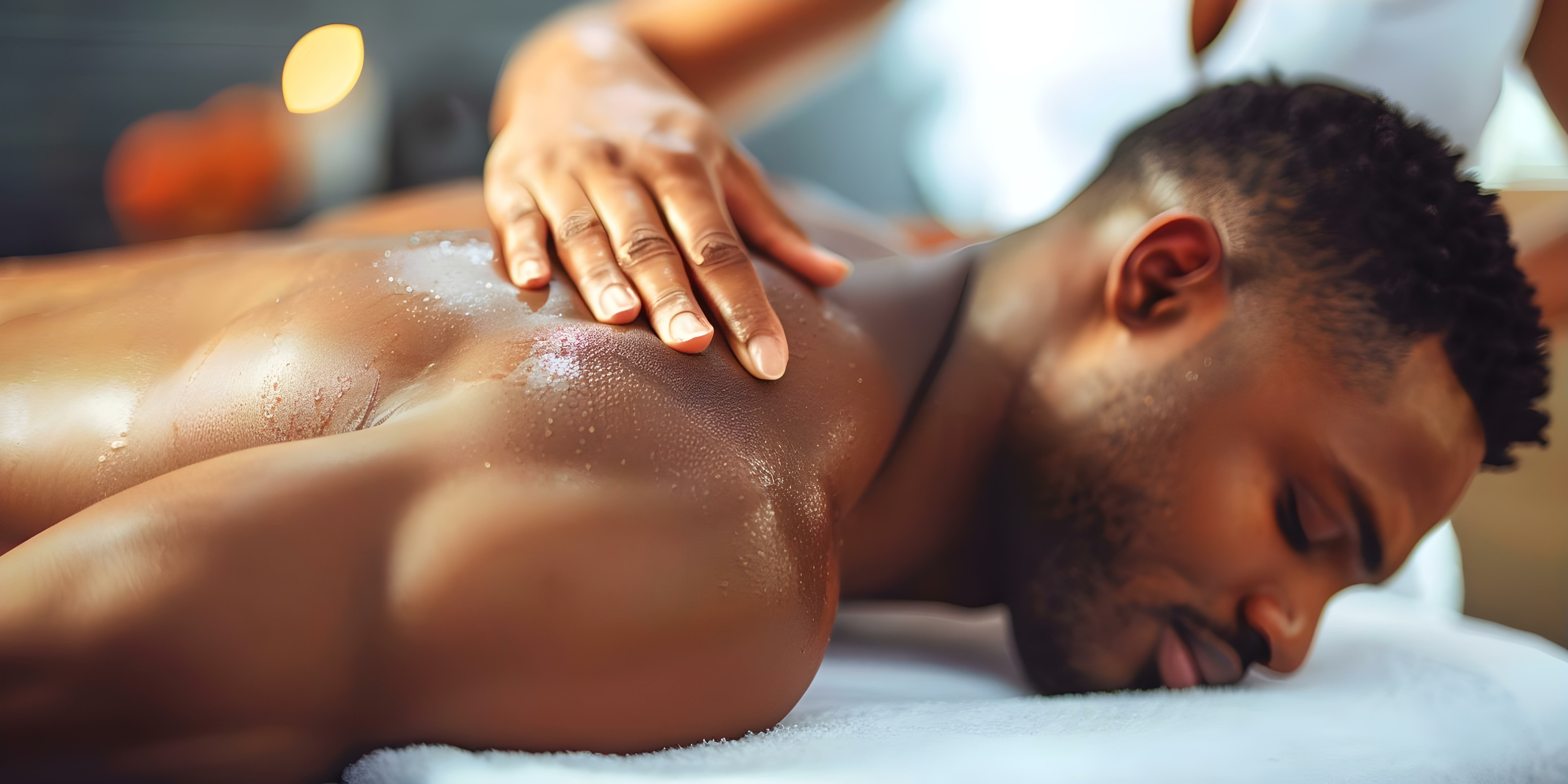 A man receiving a back massage at a spa representing relaxation and selfcare at a wellness center. Concept Relaxation techniques, Wellness centers, Massage therapy, Self-care activities