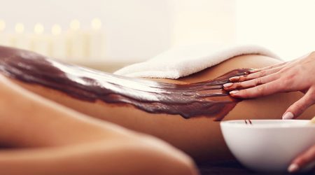 Picture of beautiful woman getting chocolate massage in spa