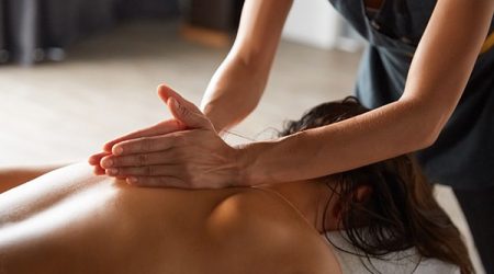 Female enjoying relaxing full body massage made made by masseuse with forearms and cubits in cosmetology spa centre. Body care, skin care, wellness, wellbeing, beauty treatment concept.