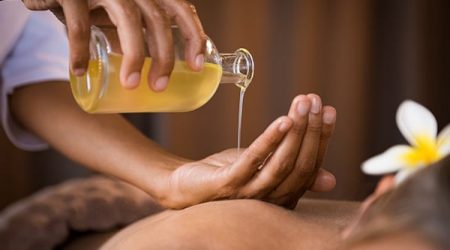 Therapist Pouring Massage Oil At Spa