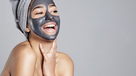 laughing woman having fun with facial mask on