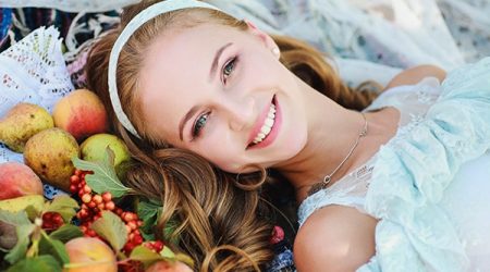 Portrait of a young beautiful girl close-up of scattered fruit a