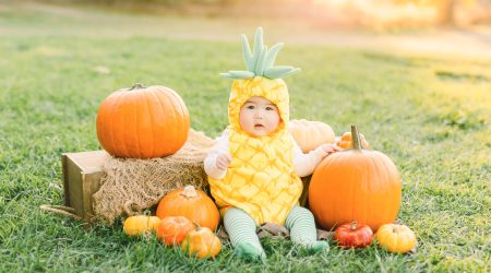 Cute baby boy dressed in halloween pineapple costume